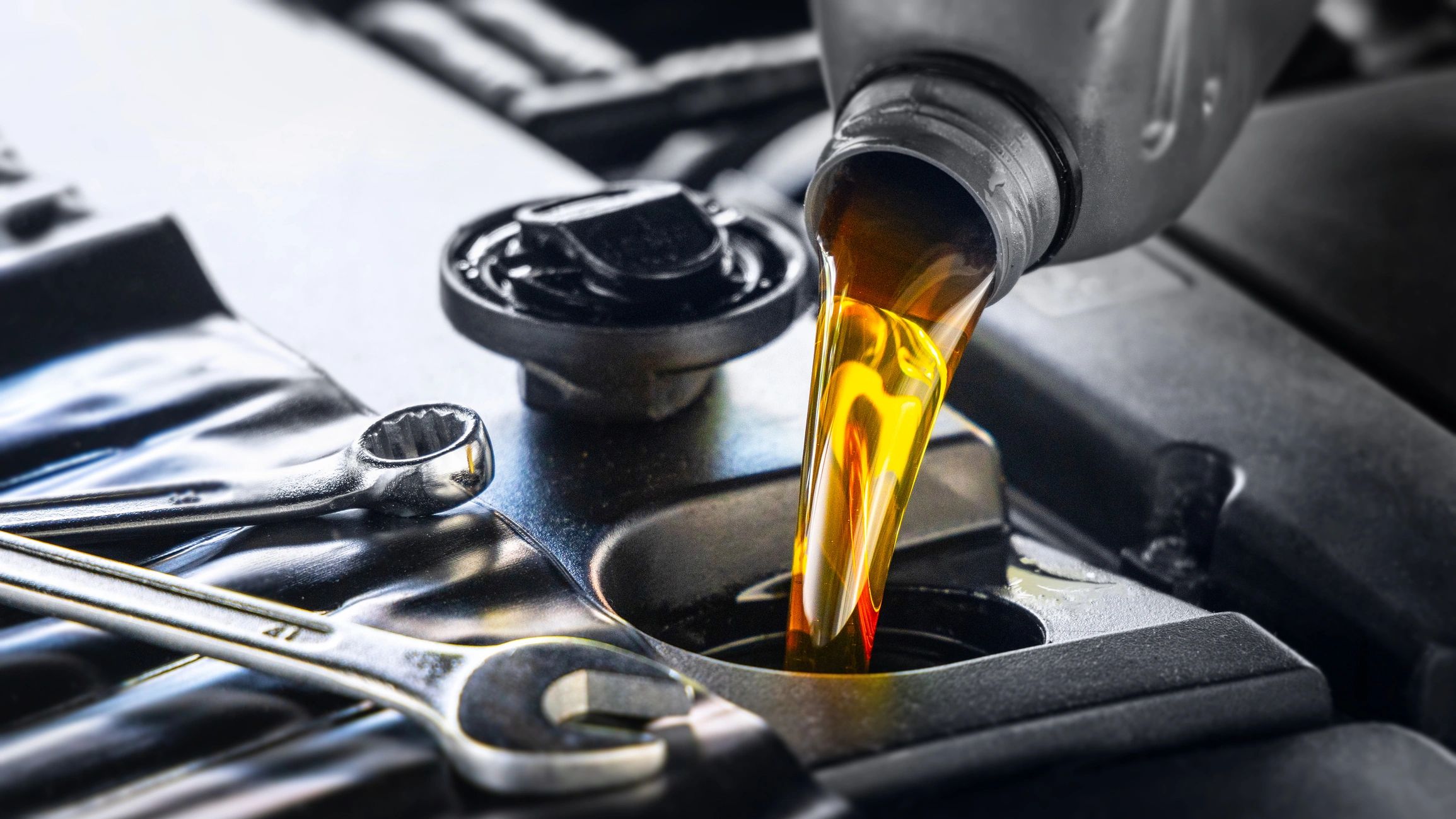 Technician performing an oil service in a modern repair shop