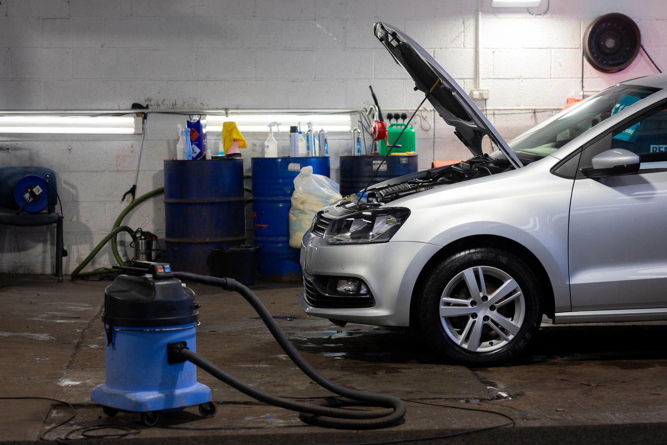 Vehicle being serviced inside a professional repair shop